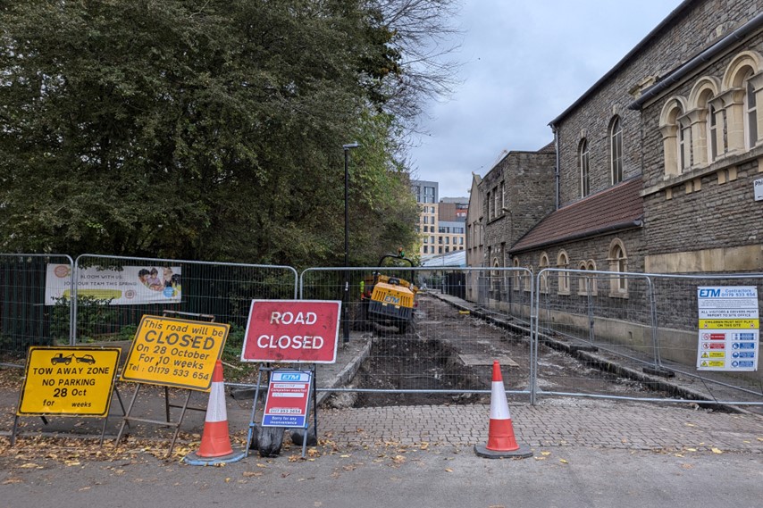 Road closure signs in front of a fenced off Clarke Street already under reconstruction