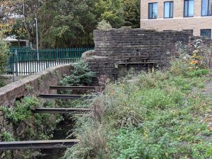 Image of the existing, dilapidated historic metal work in the River Malago channel.