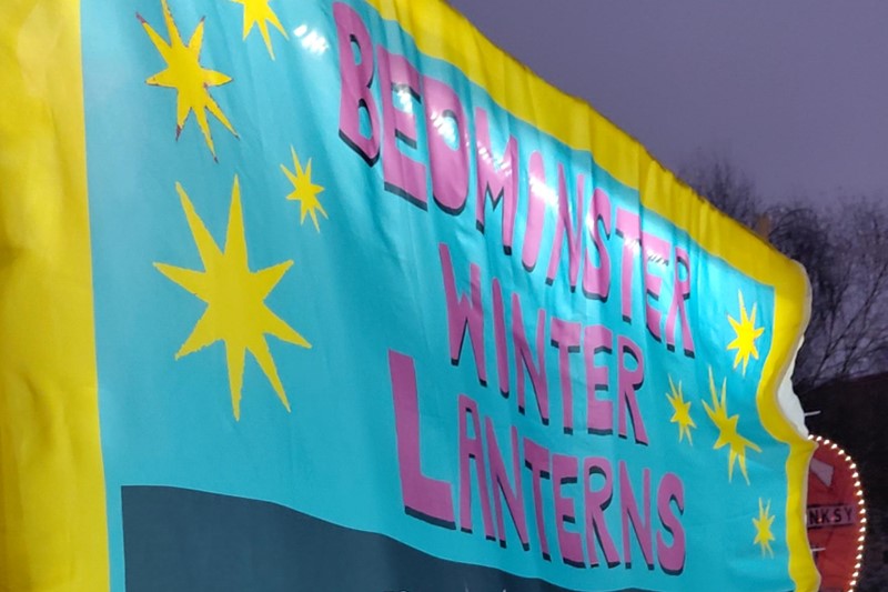 Banner reading "Bedminster Winter Lanterns" in blue, pink and yellow.